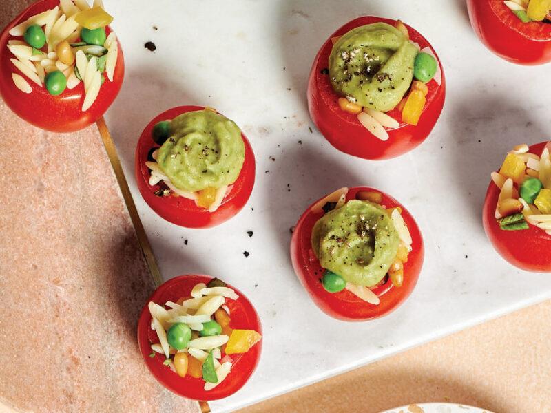 Orzo-Stuffed Tomatoes with Pesto Fluff on a white rectangular serving tray