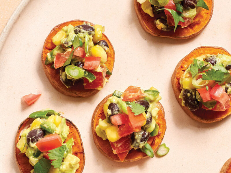 Sweet Potato Crostini with Avocado Salsa on a light pink serving tray