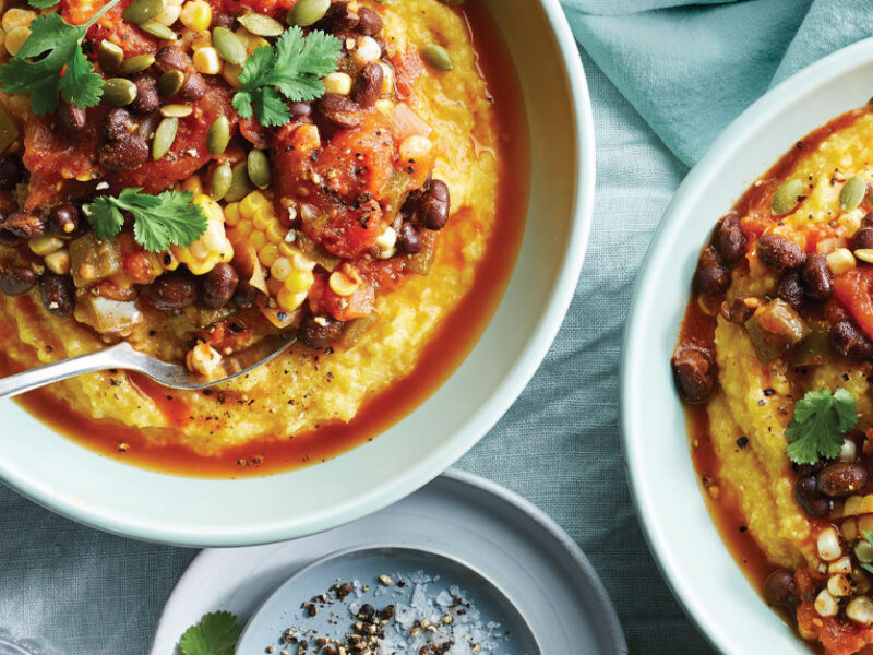 Creamy Polenta with Jalapeño Tomato Sauce in light blue ceramic bowls against a blue fabric background