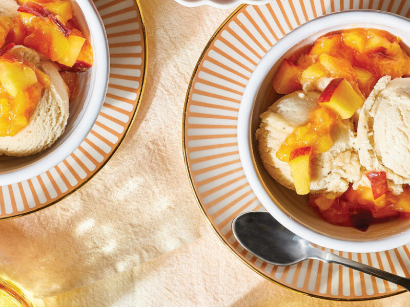 Banana Nice Cream with Easy Peach Compote in white ramekins on orange and white striped plates