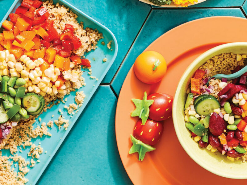 Kid-Friendly Rainbow Salad on a turquoise platter and in a yellow bowl