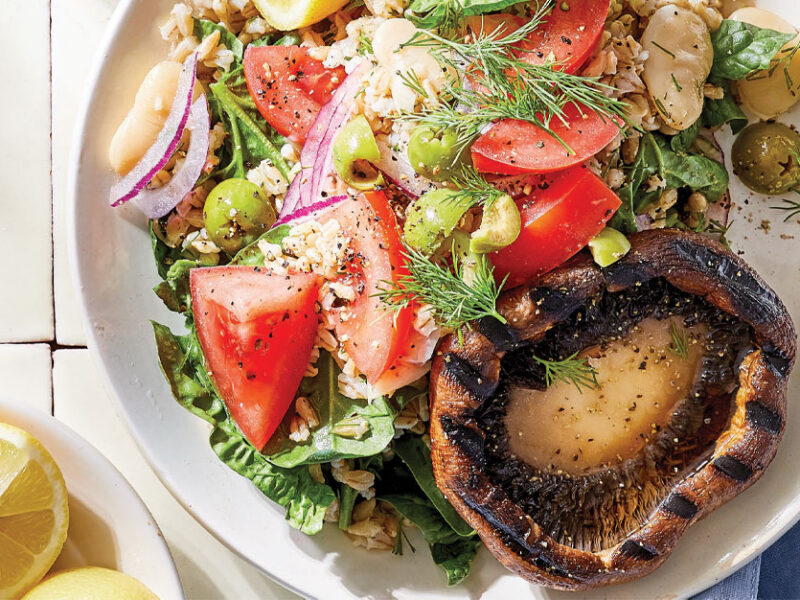 Gyro-Style Mushroom Steaks with Barley Salad on a white plate