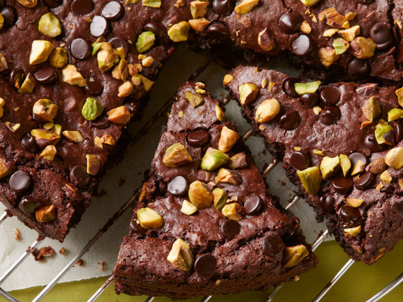 Healthy black bean brownies by Chef AJ, shaped like a pie and cut into slices, garnished with pistachios