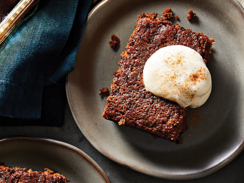 Pioneer Gingerbread with a dollop of aquafaba whipped cream on a gray ceramic plate