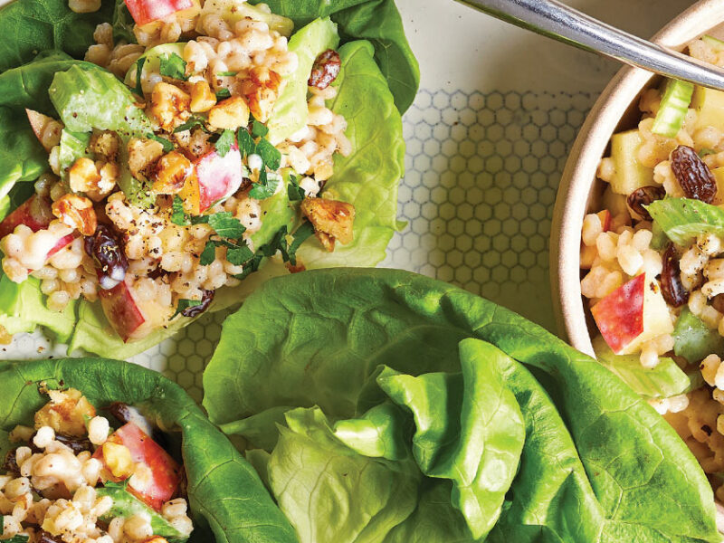 Vegan Waldorf Salad on lettuce leaves placed on a white serving tray