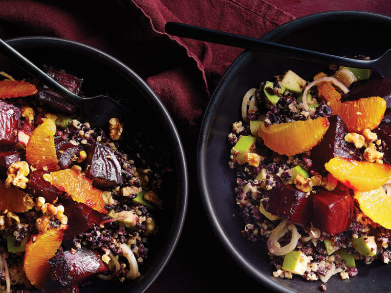 Black Rice, Roasted Beet, and Orange Salad in black ceramic bowls