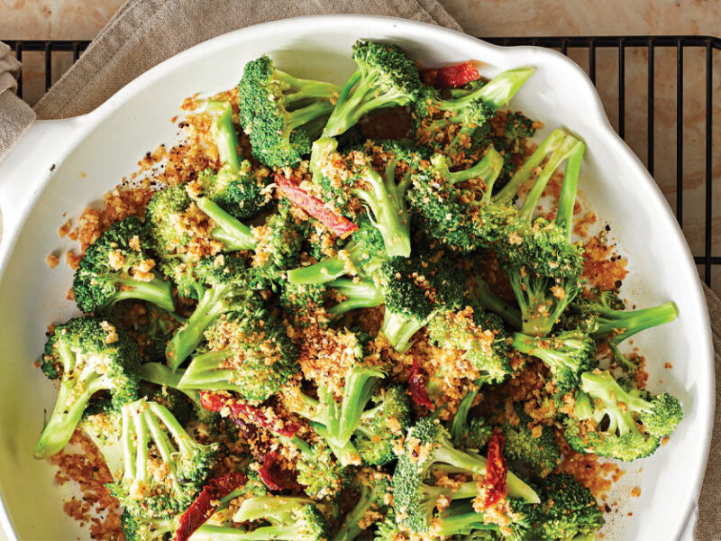 Panko Broccoli with Sun-Dried Tomatoes in a white ceramic skillet on wire cooling rack