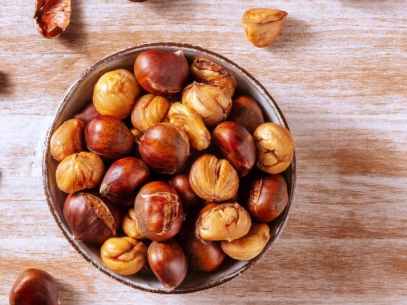 a bowl of chestnuts, some peeled so just the inner nuts remain, some with the outer layer intact