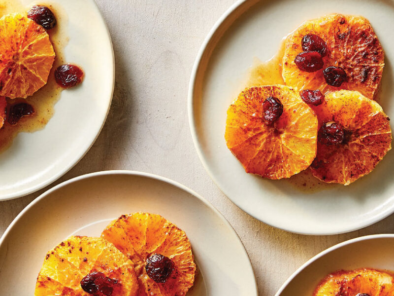 Spiced Roasted Oranges with Dried Cranberries on white plates