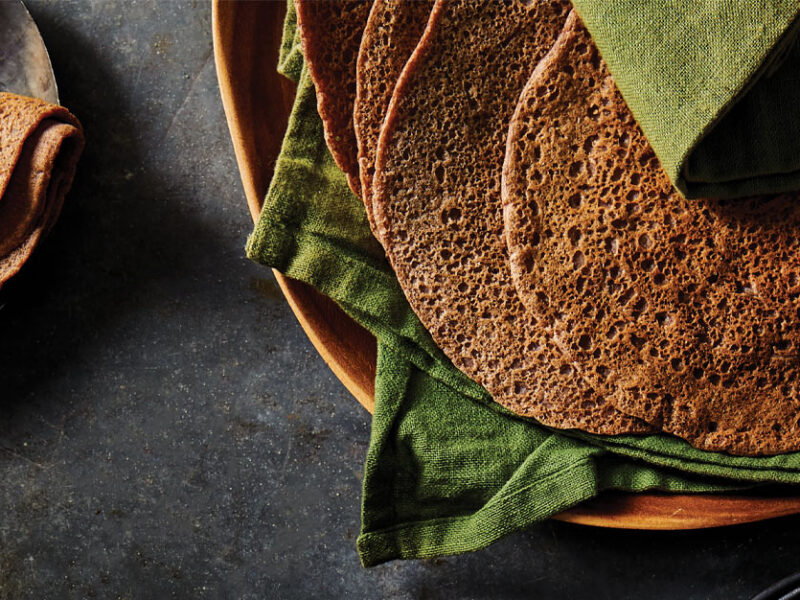 Quick and Easy Injera resting in green cloth napkins