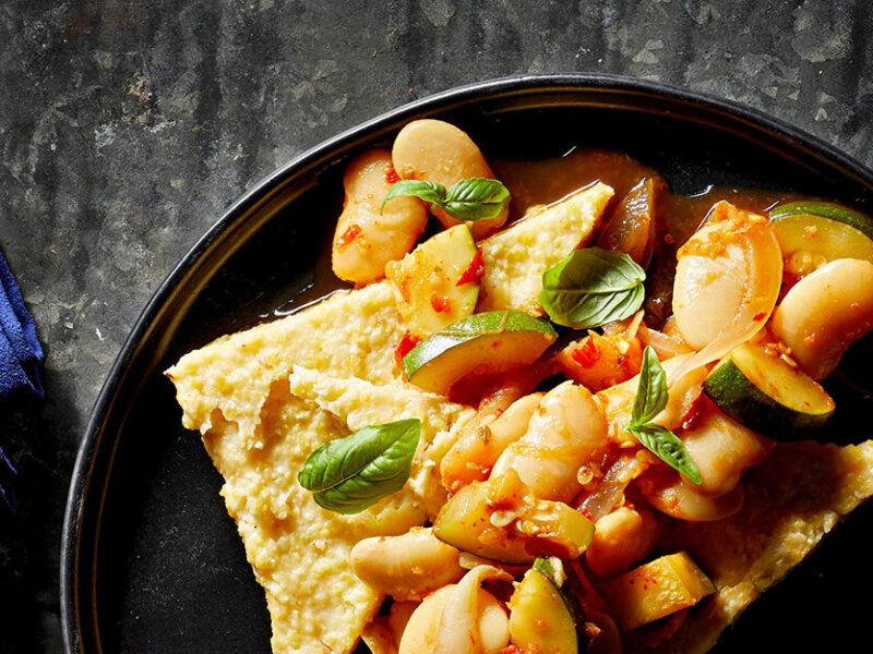 Calabrian Chile Beans and Polenta in a dark grey ceramic bowl