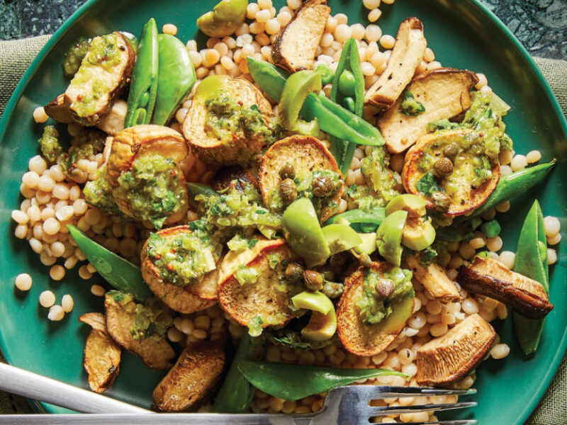 Vegan Mushroom Scallops with Spanish-Style Olive-Herb Sauce on a green plate sitting on a pale green cloth napkin