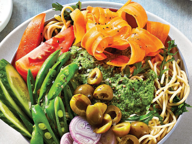 Chilled Noodle Bowls with Mixed Veggies and Minted Pea Dressing in a shallow white bowl sitting on a white plate on a pale grey tablecloth