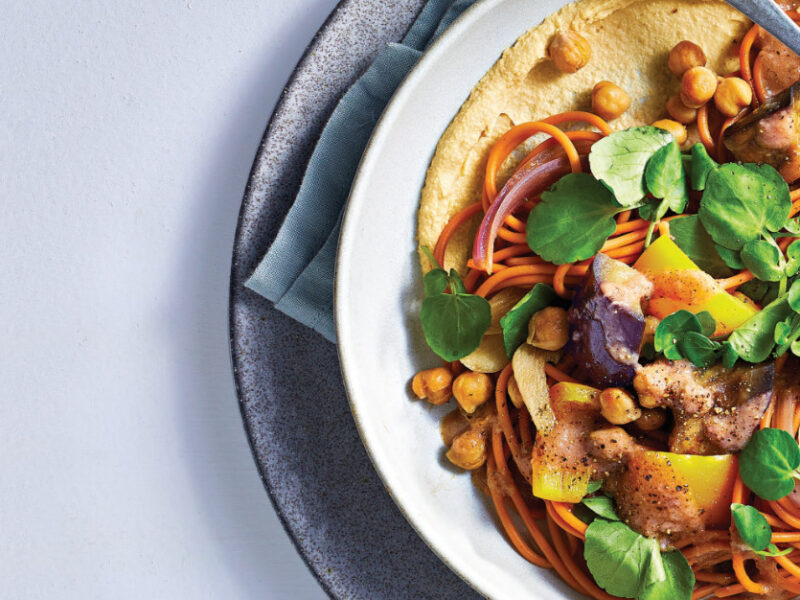 Lebanese 7-Spice Noodle Bowl with Eggplant and Roasted Garlic in a white bowl on a pale grey background