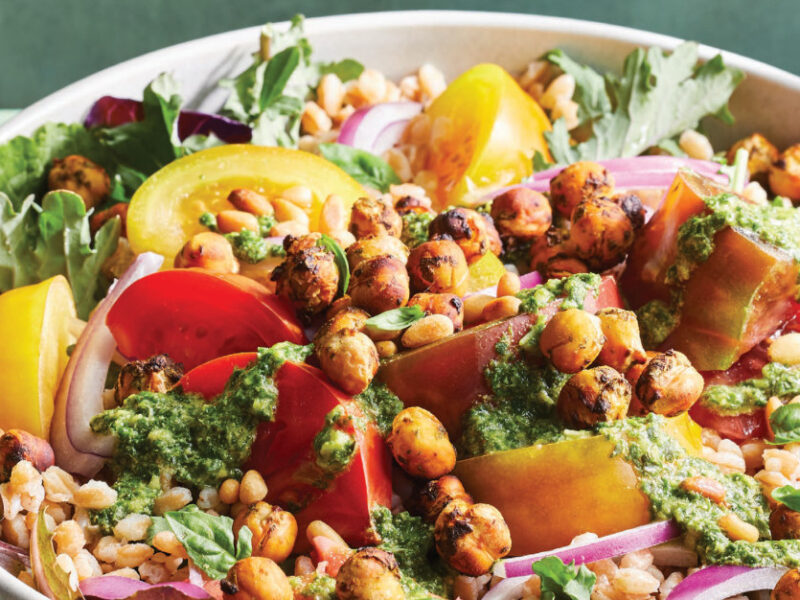 Hearty Pesto Salad with Tomatoes, Farro, and Air-Fried Chickpeas in a large white bowl