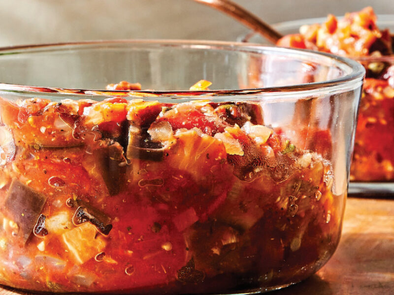 Sicilian Caponata in a glass bowl with another bowl of caponata in the background