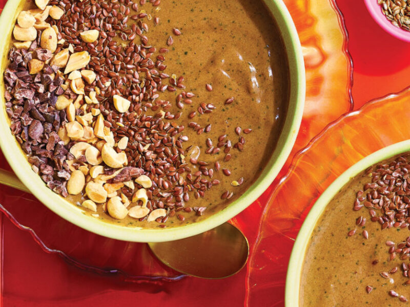 Two Chocolate Peanut Butter Smoothie Bowls on a bright orange platter against a hot pink background