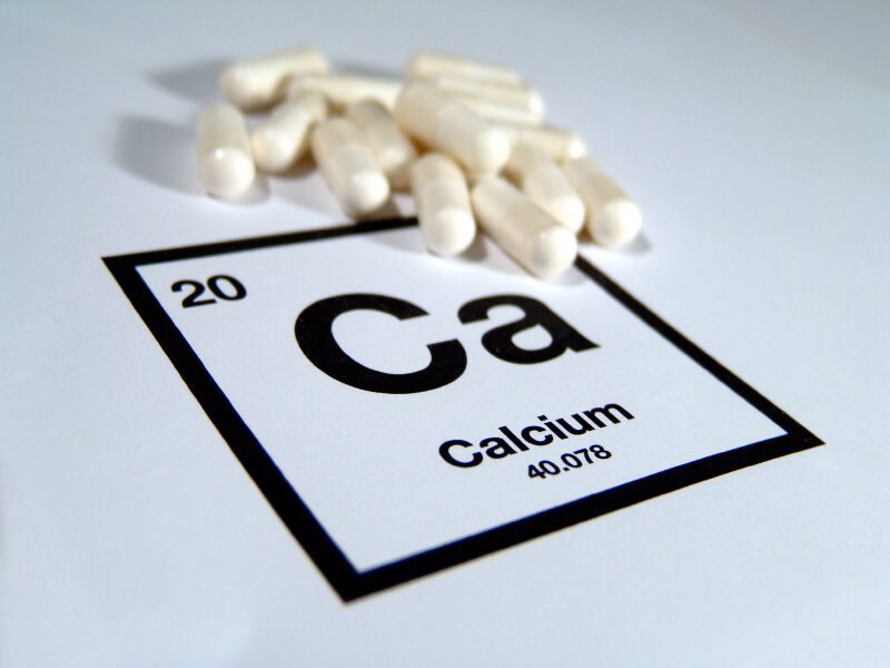 Calcium tablets on a cut out of the Calcium bock from the periodic table