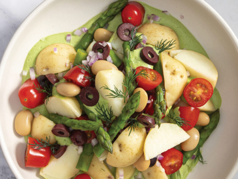 Sarah Cobacho's Creamy Dill Potato Salad in a white bowl on a marble counter