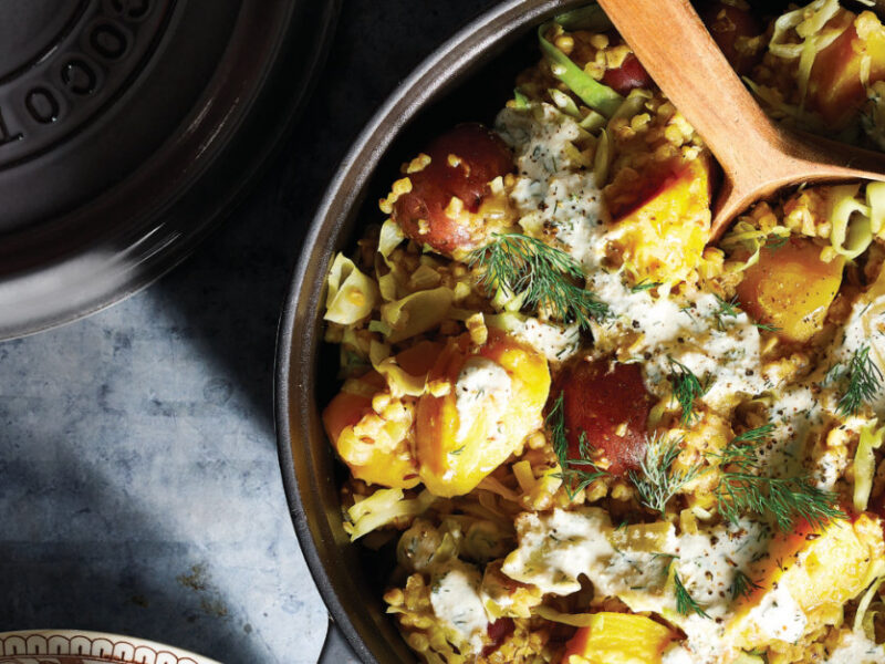 Kasha Pot with Potatoes, Cabbage, and Golden Beets in a skillet with a wooden spoon