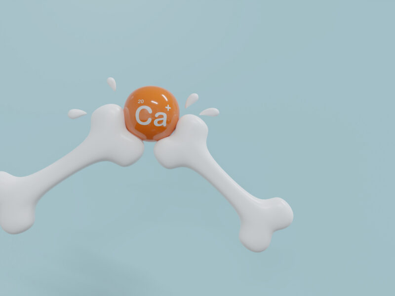 a computer-rendered image showing two plastic-looking bones intersecting at an orange ball, which has the periodic symbol for Calcium on it