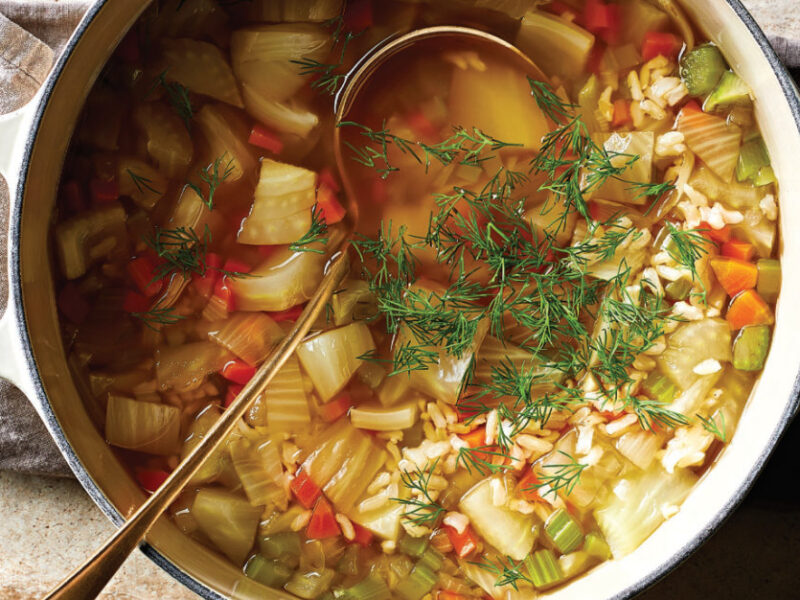A white pot with handles full of Vegan Chicken and Rice Soup