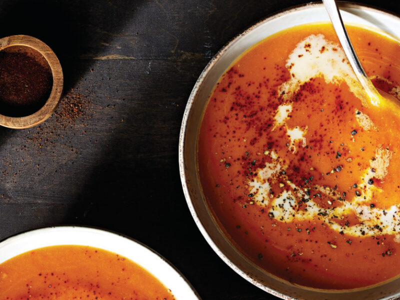 Chipotle Butternut Squash Soup in a white bowl with a serving spoon