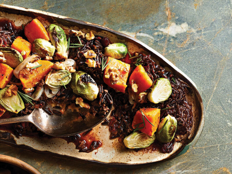 Cranberry Wild Rice with Sweet Potato and Brussels Sprouts on a long pottery serving dish