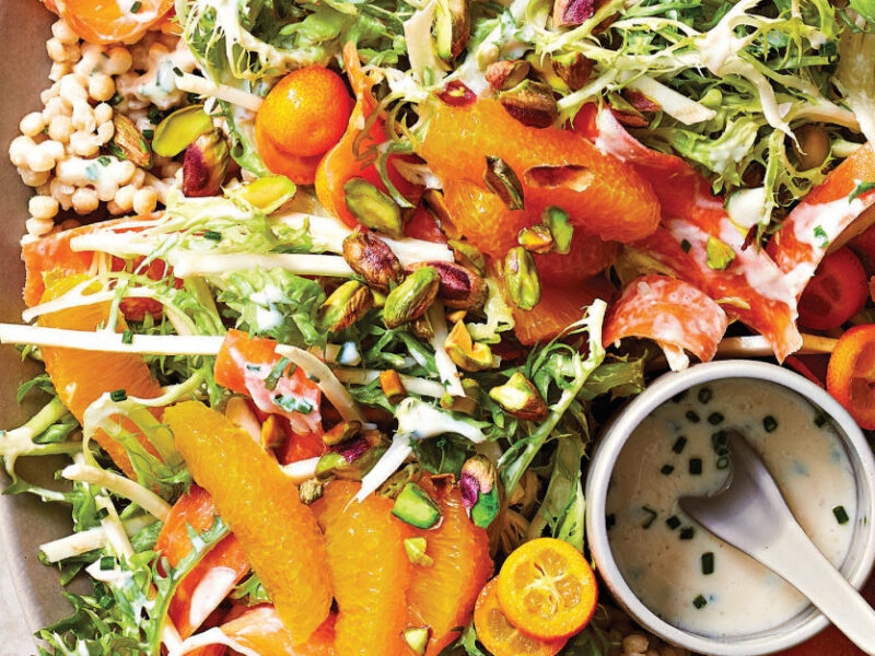 Spicy Citrus Slaw with Pearl Couscous on a large platter with a small bowl of creamy dressing