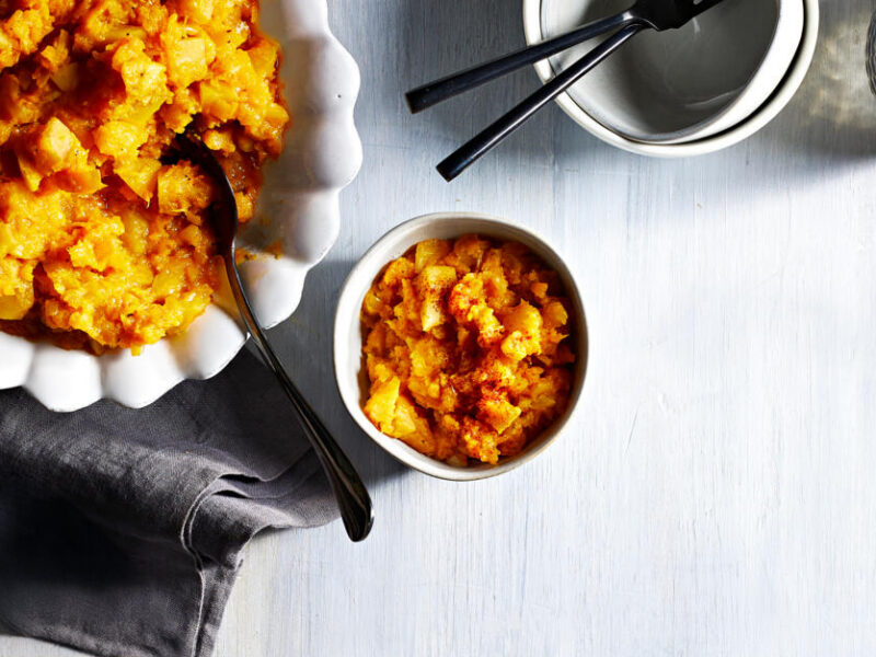Roasted Red Kuri Squash and Golden Beet Mash in a white serving dish next to a smaller, serving-size dish filled with the mash