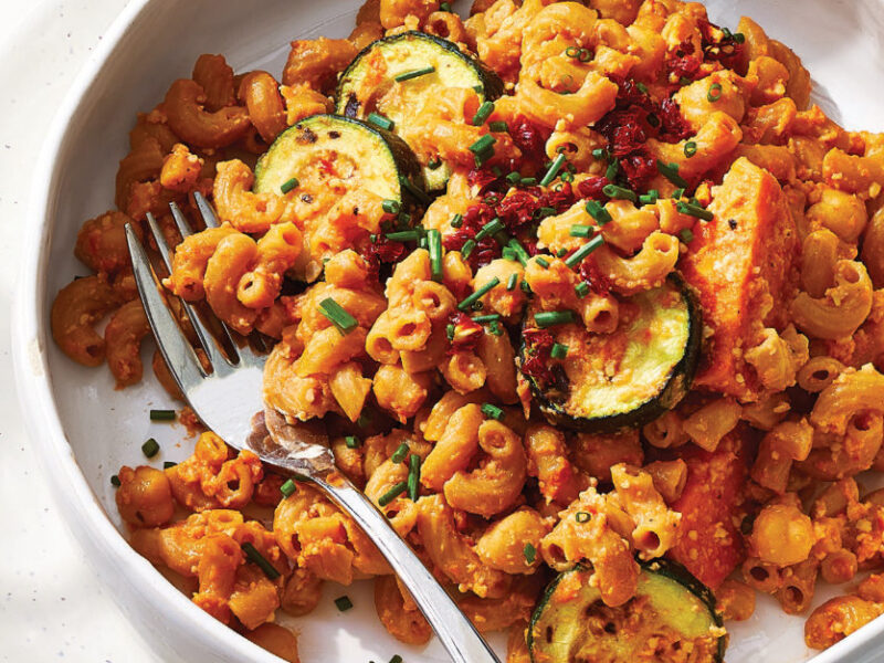 Veggie Mac and Cheese with Sun-Dried Tomatoes in a white bowl resting in a white plate on a white tablecloth