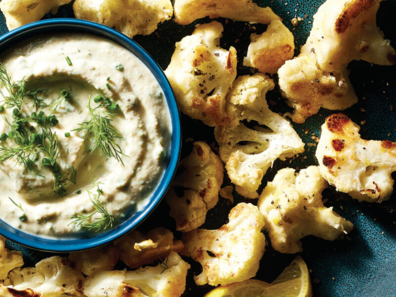 Crispy Cauliflower Bites on a platter with a small bowl of Ranch Dip in the middle