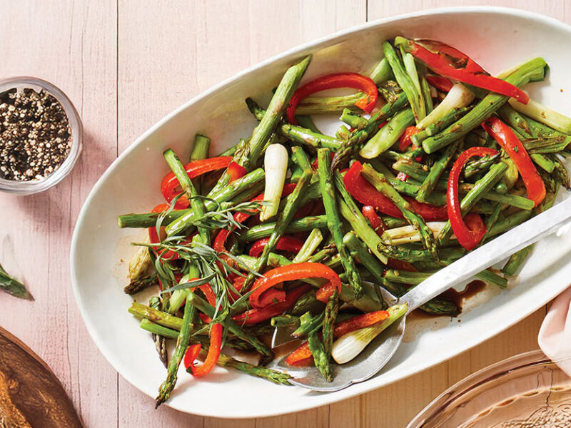 Roasted Asparagus with Tarragon and Balsamic on a white oval serving platter