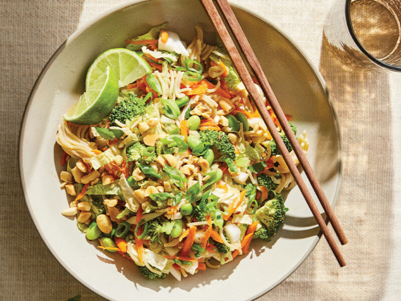 A bowl of Thai-Style Slaw with Peanuts and Ramen Noodles with chopsticks on the side