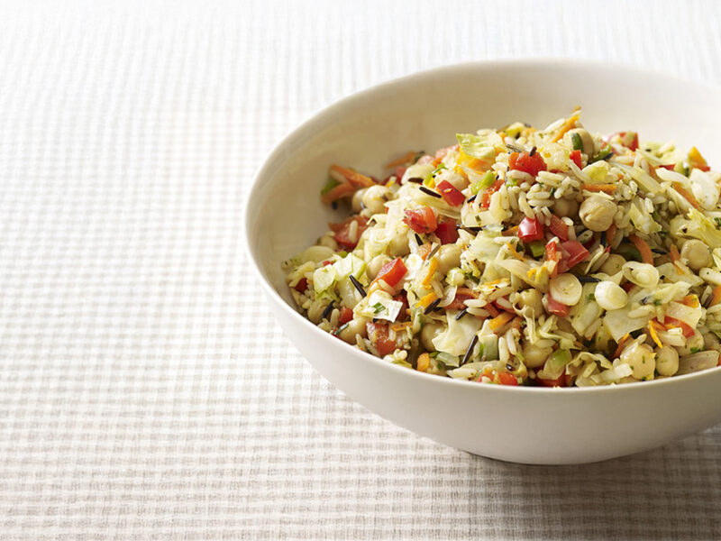 Wild Rice, Cabbage and Chickpea Pilaf in a white bowl on a pale checkered table cloth