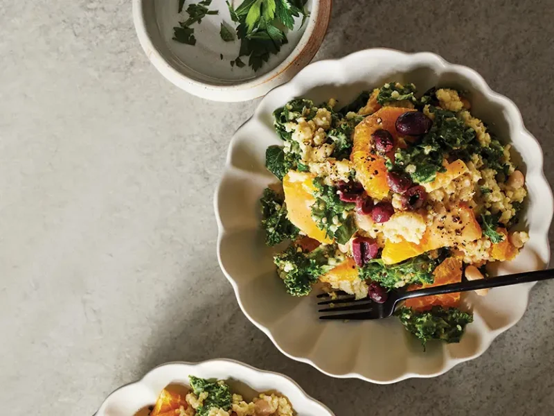 Citrusy Millet Salad in a white bowl with a fork in the bowl