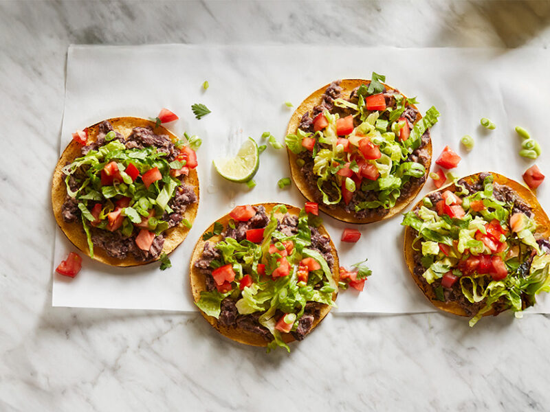 Quick Black Bean Tostadas on a marble background