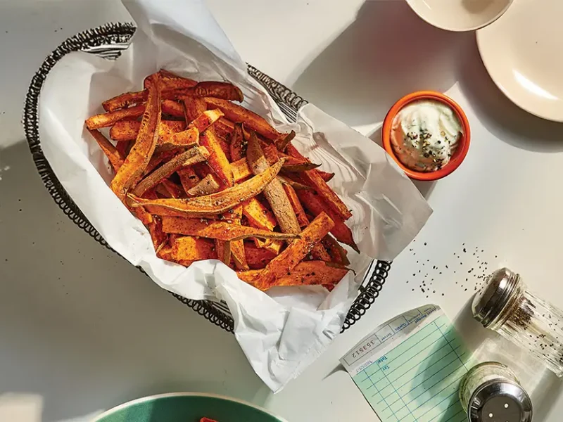 Smoky Sweet Potato Fries in a basket with a small bowl of sweet potato fries Dipping Sauce