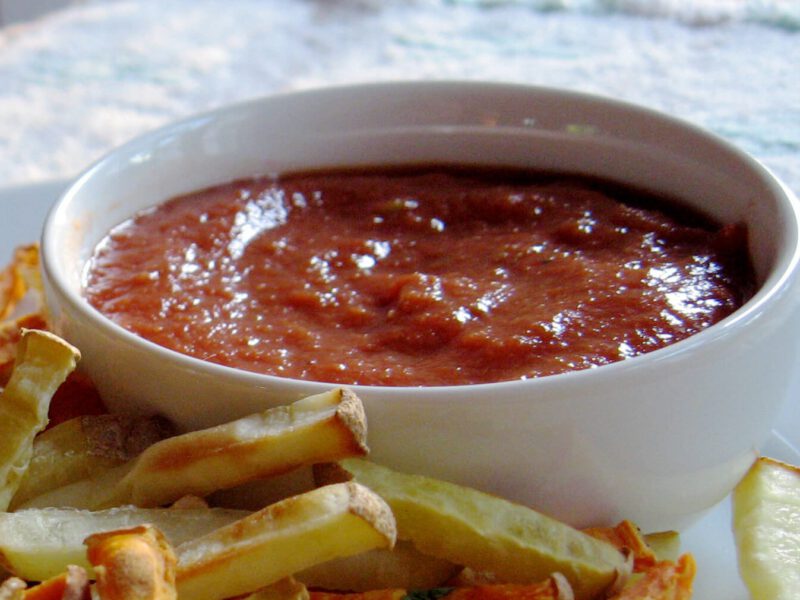 5-Minute Ketchup in a white bowl with baked oven chips surrounding