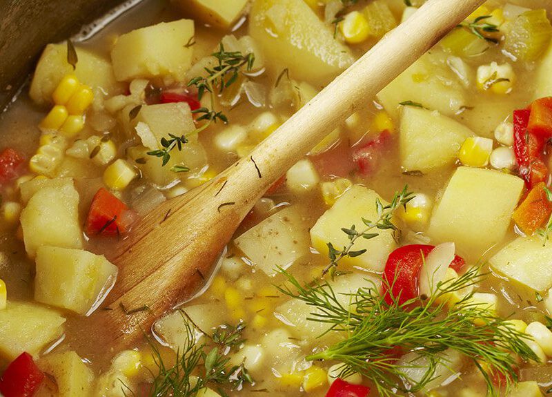 A closeup of Lotsa Vegetable Chowder in a large cooking pot