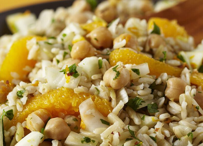 A bowl of rice salad with oranges and chickpeas