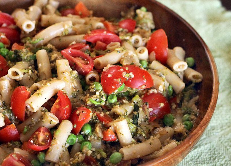 Pasta Primavera in a wooden serving bowl with a wooden serving spoon