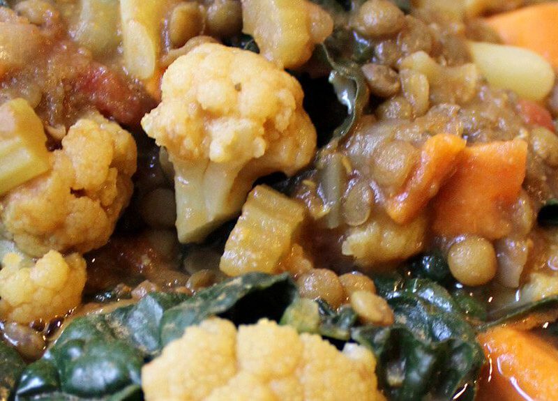 A close-up of Curried French Lentils with cauliflower and chard