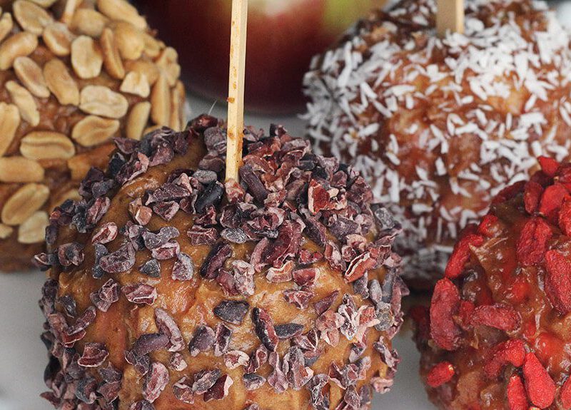Healthy Caramel Apples covered with nuts, goji berries, and coconut