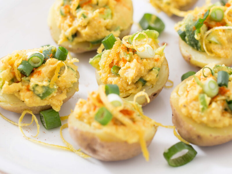 Smoky Little Devils on a white serving platter topped with sliced green onion