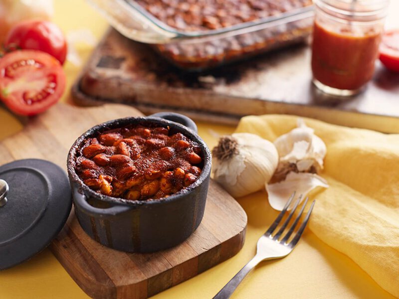 A single-serve cast-iron pot of homemade baked beans