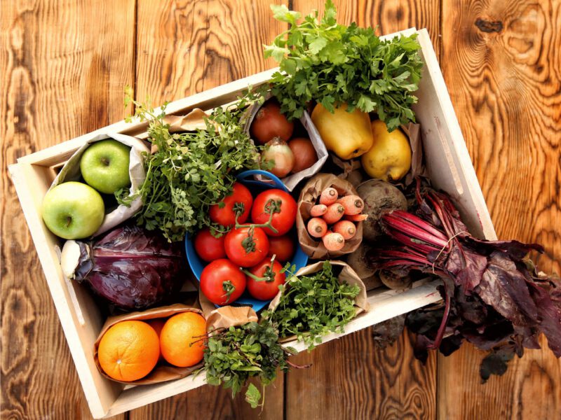 Looking down at a basket of fresh fruits and vegetables