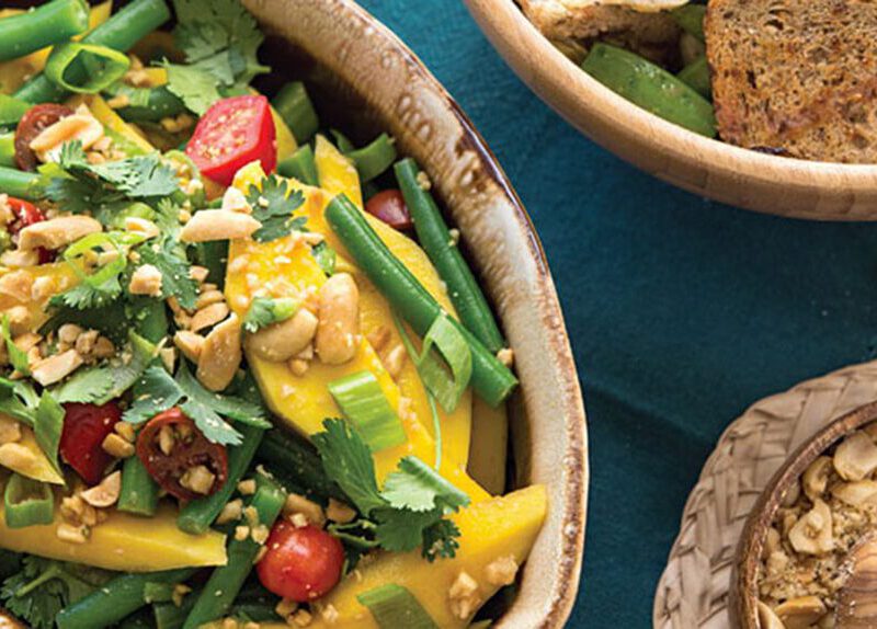 Green Bean and Mango Salad in a rustic, oval, ceramic serving bowl
