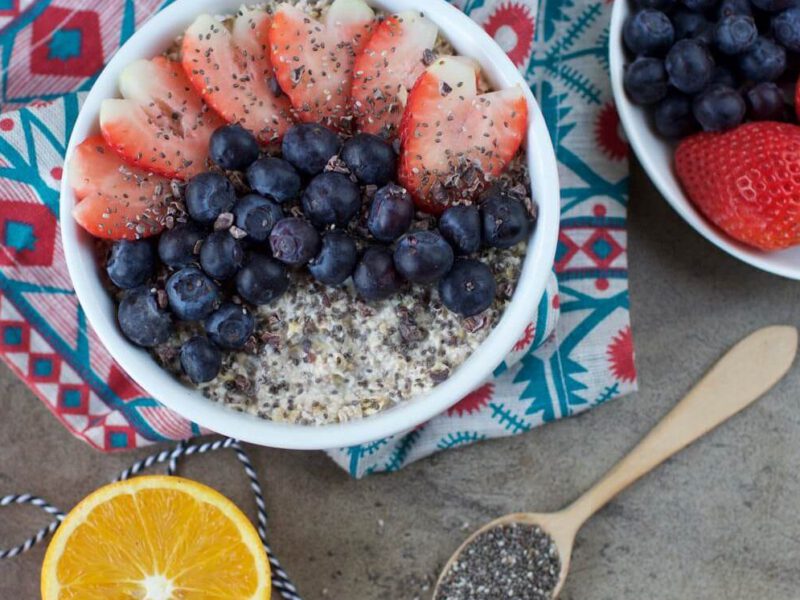 A bowl of oats with blueberries and strawberries