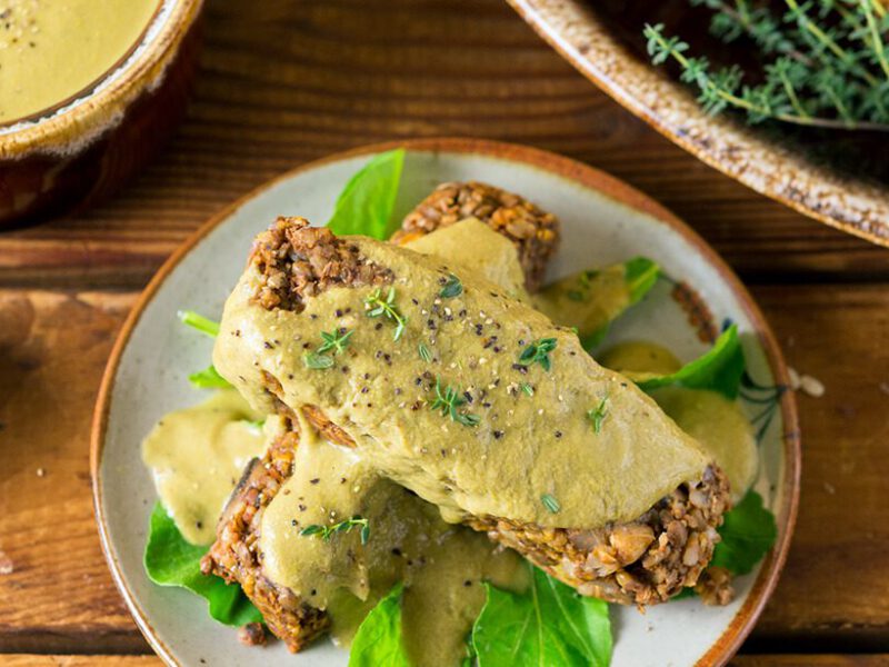 Two slices of Lentil Rice Loaf on a wooden table